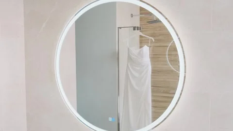 A wedding dress hangs in the bathroom of a multi-story hotel with panoramic wind Stock Footage 309497178