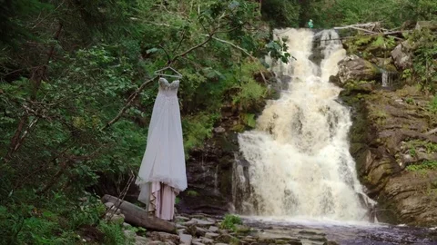 Wedding dress near waterfall Stock Footage