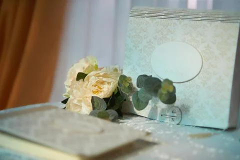 Wedding elements, guest book and mini bouquet flowers on table Stock Photos