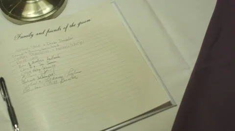 Wedding event guest book signed pan over Vídeos de archivo 35857730