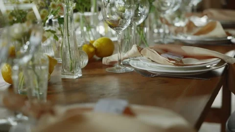 Wedding festive table set with plates with peach down napkins and fresh flowers Stock Footage 259061742