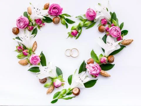 Wedding flat lay. Heart frame roses and buds on a white background. Decorativ Stock Photos