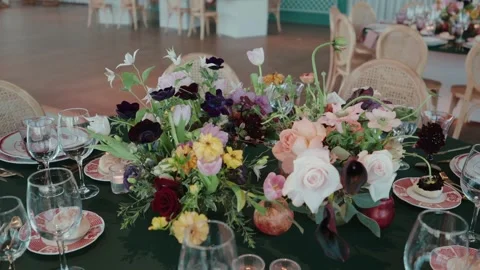 Wedding floral centerpiece with table setting glassware and candles Stock Footage 333107768