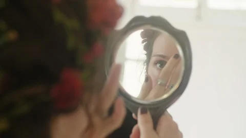 Wedding Getting Ready: Attractive young Bride checks her makeup in her mirror Stock Footage 119986837