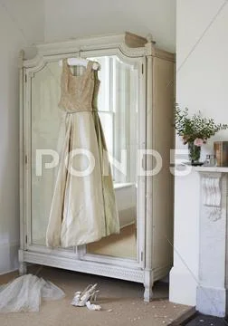 Wedding Gown Hanging From Wardrobe