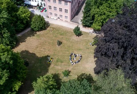 Wedding guests lined up in the shape of heart with bride and groom marriage p Stock Photos