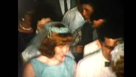 Wedding guests walking into hall (Full Frame).8mm 1960s  Stock Footage