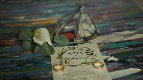 Wedding invitation and rings on the table Stock Footage 130650243