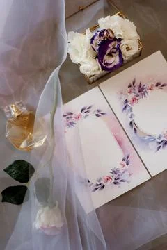 Wedding invitation in a gray envelope on a table with green sprigs Stock Photos