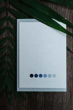 Wedding invitation in a gray envelope on a table Stock Photos