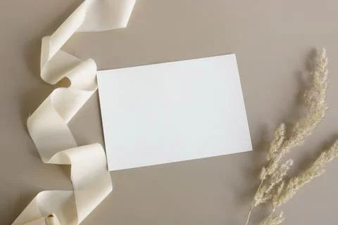 Wedding invitation mockup, empty blank card mock up with white silk ribbon and d Stock Photos
