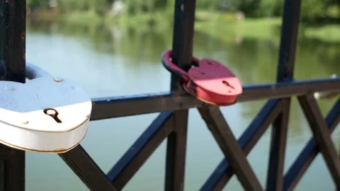 The wedding lock hangs on the railing of the bridge Stock Footage 78447648