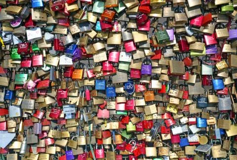 Wedding Locks on bridge. Red heart lock attached to bridge grating. Stock Photos