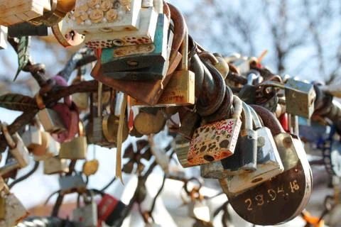 Wedding locks chained to the bench in city park Stock Photos
