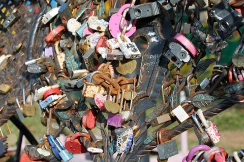 Wedding locks chained to the bench in city park Stock Photos