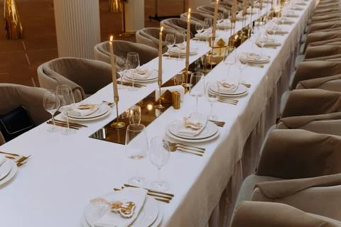 Wedding luxury table setting crystal wine glass and gold forks and knives. Ca Stock Photos