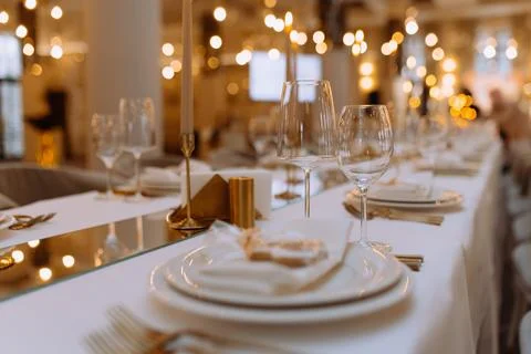 Wedding luxury table setting crystal wine glass and gold forks and knives. .. Stock Photos
