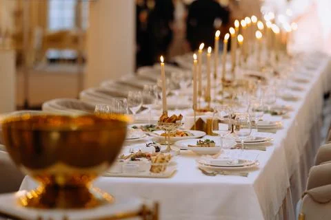 Wedding luxury table setting crystal wine glass and gold forks and knives. .. Stock Photos