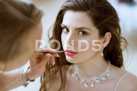 Wedding makeup artist making a make up for bride Stock Photos
