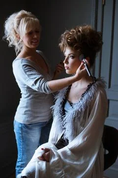 Wedding makeup artist making a make up for bride Stock Photos