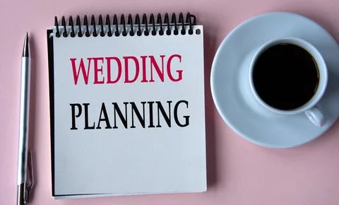 WEDDING PLANNING - words in a white notebook on the background of a cup of co Stock Photos