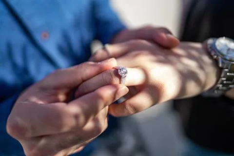 Wedding proposal, a man putting a ring on a woman's finger | Couple in love Stock Photos