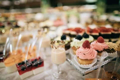 Wedding reception, candy bar, dessert table with delicious cakes and cookies Stock Photos