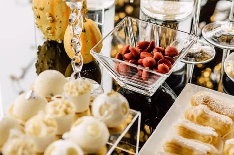 Wedding reception dessert table with delicious decorated white c Stock Photos