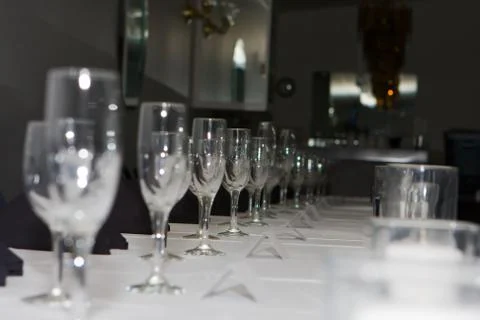 Wedding reception dinner table glasses lined up. Stock Photos