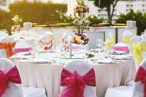 Wedding reception dinner table setting with flower decoration Stock Photos