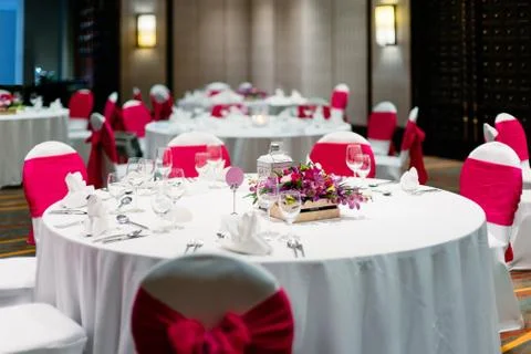 Wedding reception dinner table, white and red theme chairs Stock Photos
