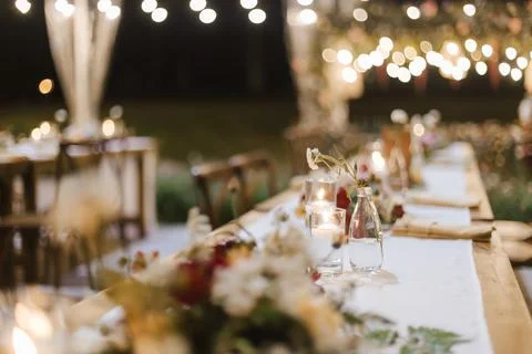 Wedding reception night dinner setup table with beautiful flower decoration. Stock Photos