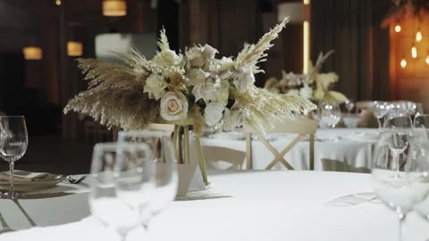 A wedding reception table set with a vase of flowers Stock Footage 306361423