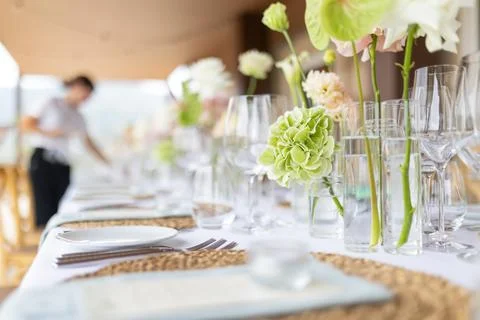 Wedding reception table setting with green floral centerpieces Stock Photos
