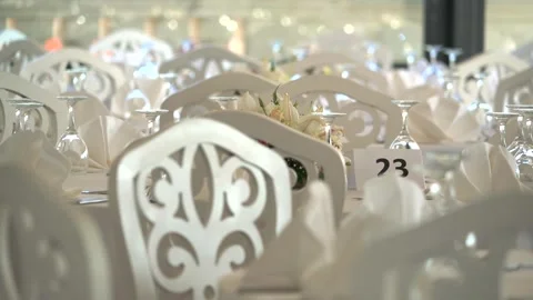 Wedding reception tables, place settings and empty chairs - Nuptial Banquet Stock Footage 339842177