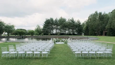 Wedding registration chairs stand in rows on a green lawn Video stock 284154465