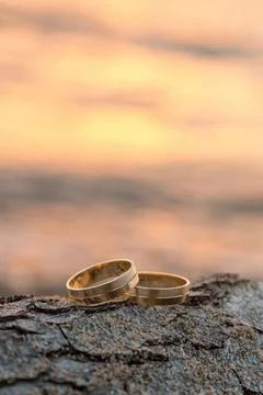 Wedding ring on the beach at sunset. Stock Photos