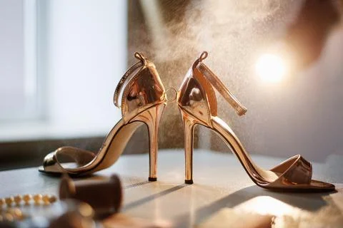 Wedding ring between the shoes in the background light Stock Photos