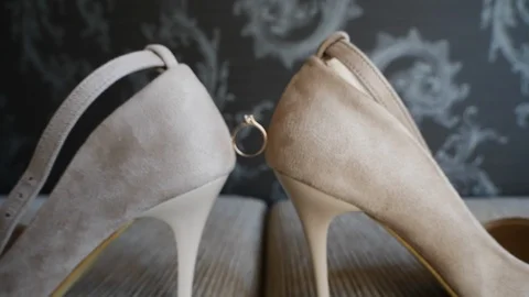 Wedding ring between shoes Stock Footage 100166930