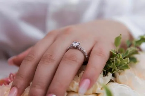 Wedding ring with bride hand Stock Photos
