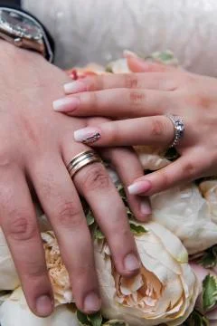 Wedding ring with bride hand Stock Photos