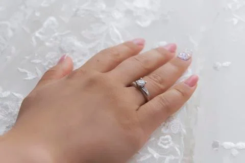 Wedding ring with bride hand Stock Photos