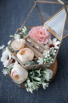 Wedding ring on a cage with flowers Stock Photos