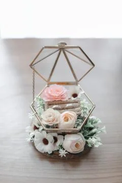 Wedding ring on a cage with flowers Stock Photos