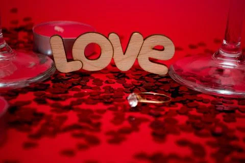 The wedding ring on the candy of hearts next to the inscription of love Stock Photos