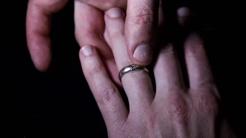 A wedding ring with diamonds is put on the ring finger Stock Footage 165699715