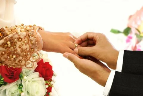 Wedding ring exchange ceremony between bride and groom Stock Photos