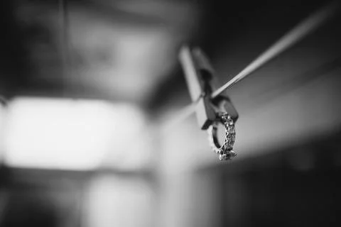 Wedding ring hangs on the clothespin Stock Photos