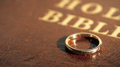 Wedding ring on Holy Bible Stock Footage 291137495