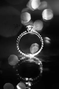 Wedding ring on the reflecting surface with highlights Stock Photos